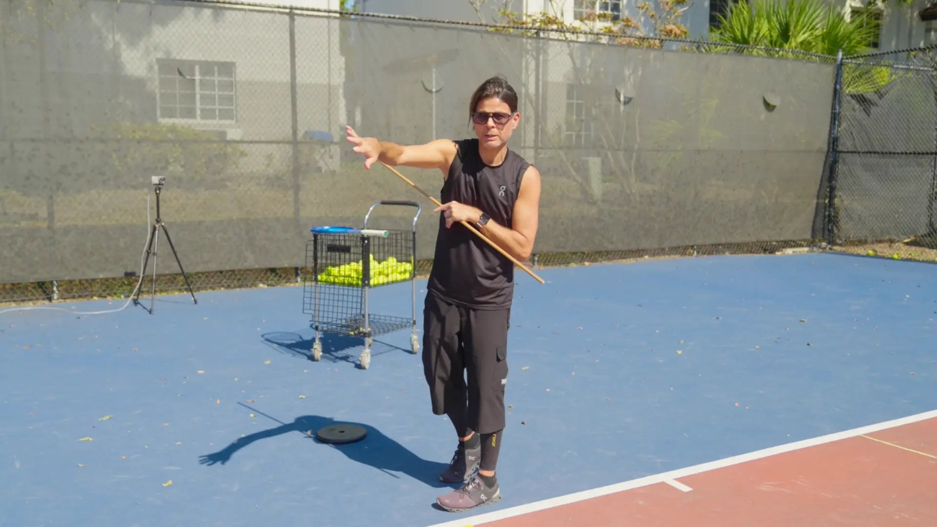 How the Tossing Arm Stabilizes the Serve